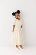 Mädchenkleid aus Baumwollgaze in Creme